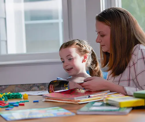 Mother and daughter doing homework at home