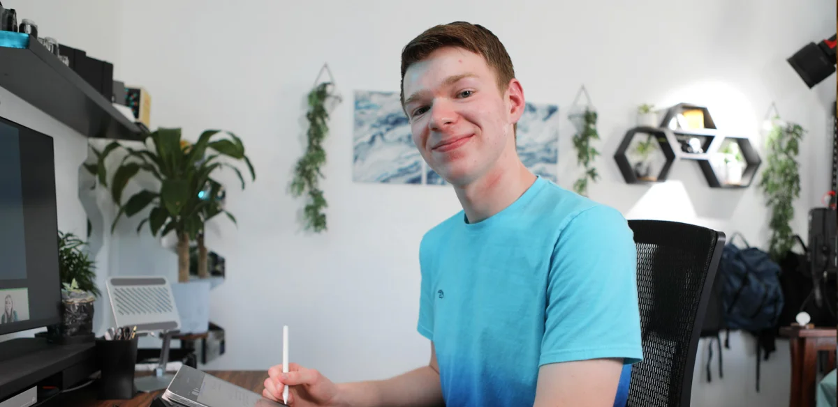 boy smiling and studying at home
